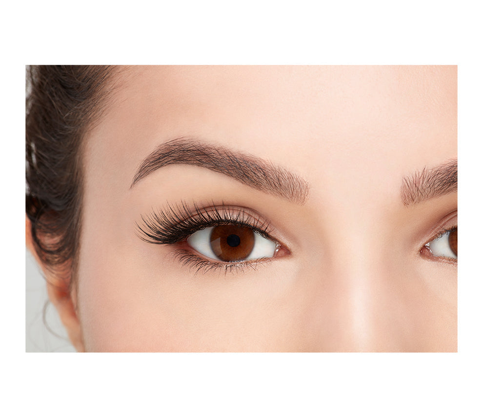 A model wearing Ardell's Faux mink 811 with open right eye showing its finely tapered end & the flared, winged out style