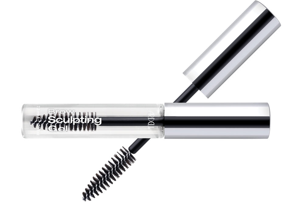 Capped bottle of Ardell Clear Eyebrow Gel that laid on its side with brush cap featured on background