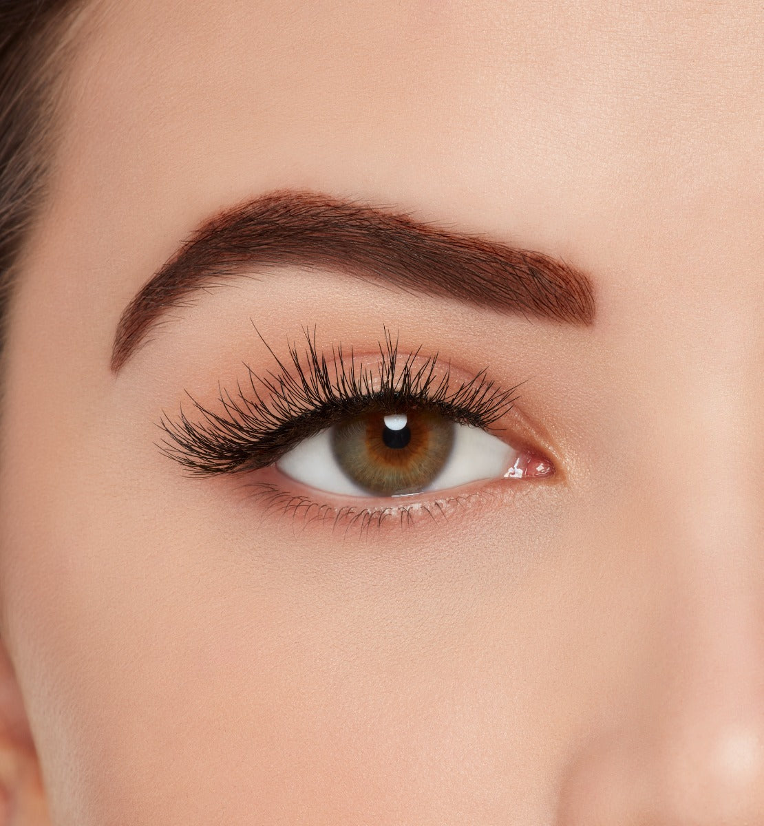 A model wearing Ardell Naked Lashes 429 featuring a flirty flair, with a slight cluster effect and a round silhouette