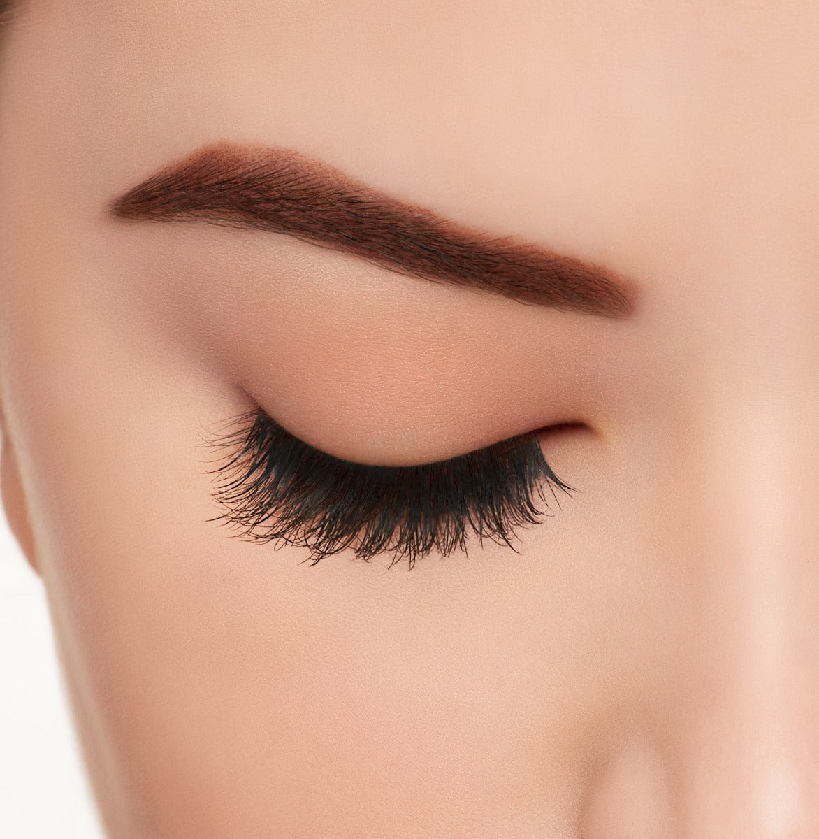 A woman with close eye wearing Ardell Active Lash Pump'n lashes